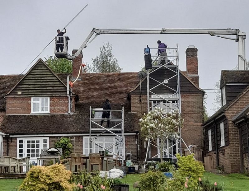 The Moss Cleaners using cherry picker and scaffolding to clean roof safely and professionally in Downend, Gloucestershire